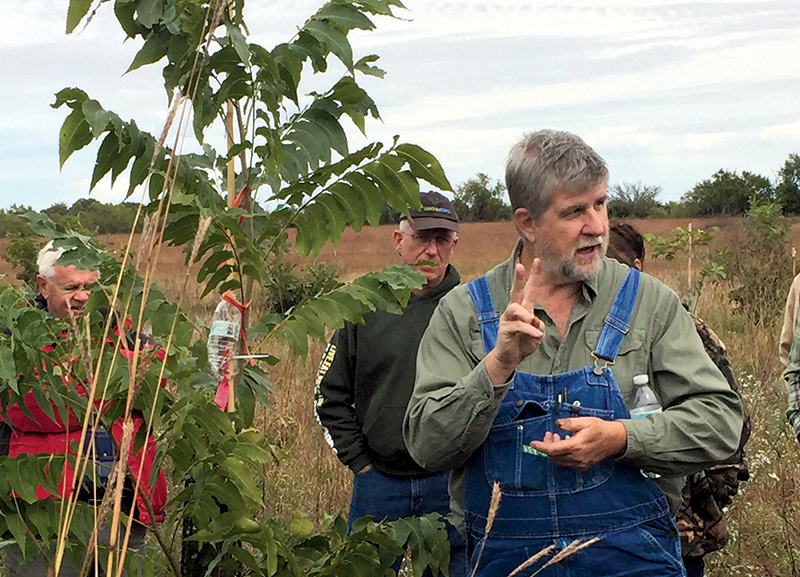 Bill Reid, director of K-State’s Pecan Experiment Field in Chetopa, Kansas, shares his expertise at one of the many pecan field days he has hosted for K-State Research and Extension. Reid is retiring in July and hosting his final field day June 6.