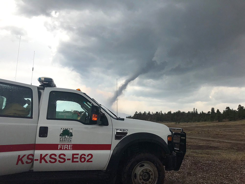 A Kansas Forest Service truck deployed to fight the Weston Pass Fire in Colorado, is forced to pause on July 5 as a tornado passes outside the town of Fairplay.