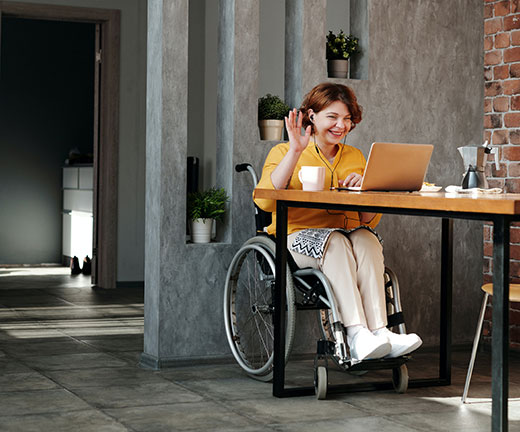 Woman in wheelchair looking at laptop computer