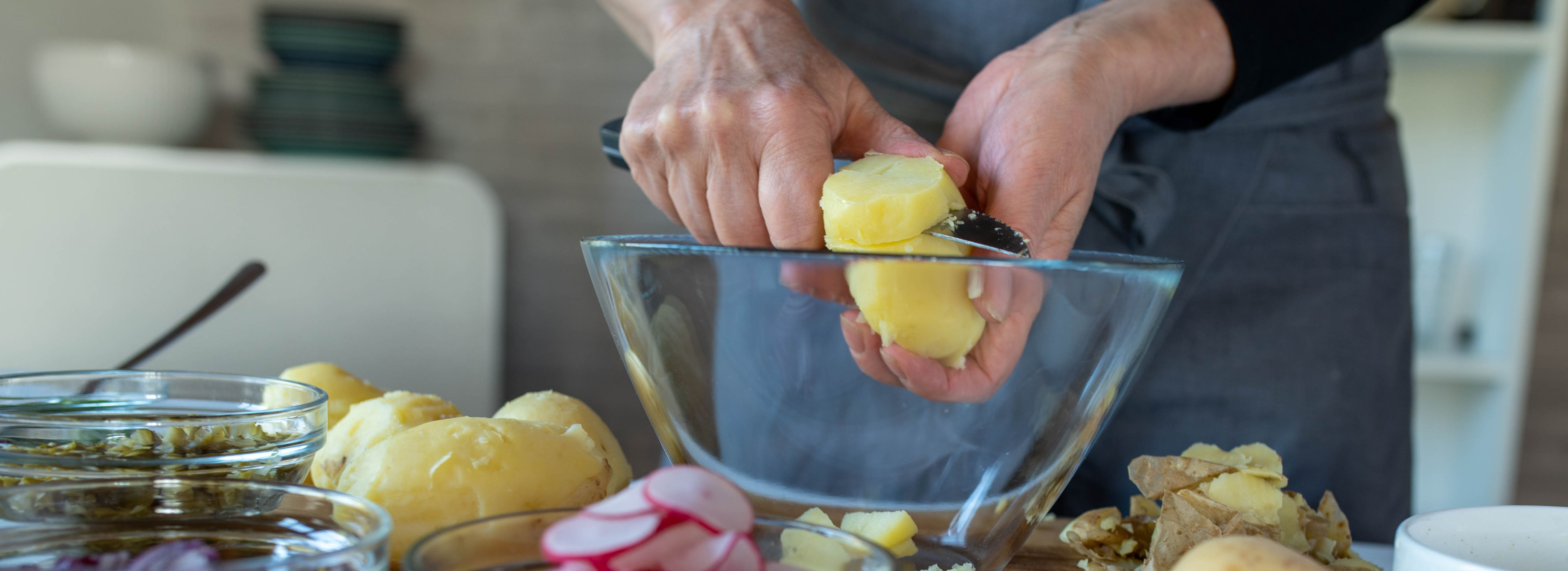 Woman cutting up potatoes. Woman cutting up potatoes.