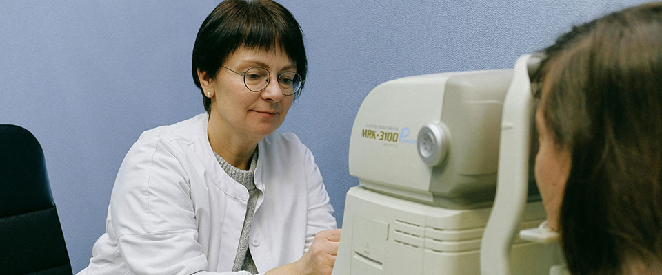 Woman administering a vision test to patient