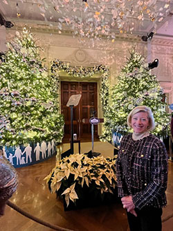 Wendy Clay standing inside main entrance of White House with decorations in background Wendy Clay standing inside main entrance of White House with decorations in background