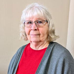 portrait of woman with glasses and red shirt