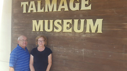 Two people standing in front of sign, Talmage Historical Museum