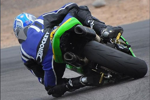 Motorcycle rider taking a tight turn Motorcycle rider taking a tight turn