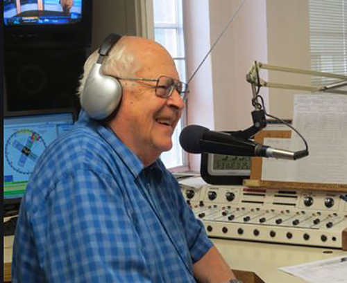 Tad Felts speaks into a microphone in a radio studio.