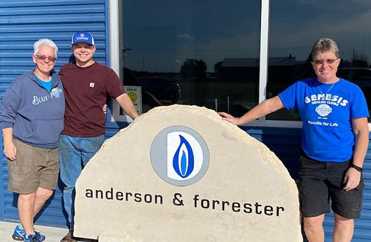owners of anderson and forrester, standing in front of office building