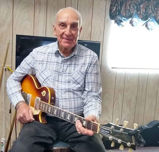 Man holding guitar, Bob Delk Man holding guitar, Bob Delk