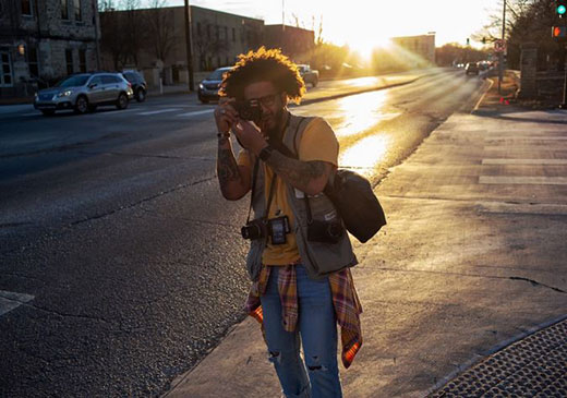Man taking picture on city street Man taking picture on city street