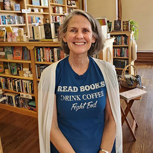 Jennifer Kassebaum, in front of shelves of books