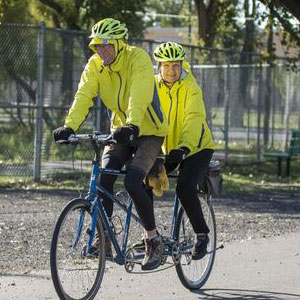 man and woman riding tandem bike
