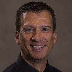 Portrait, man with dark hair smiling, Ken Frank