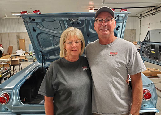 Jackie and Todd Sump standing in front of restored Ford Fairlane