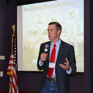 Man giving presentation, Tyler Lindholm, blockchain