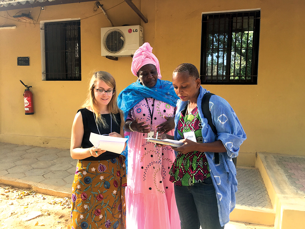 Peace Corps volunteers and training team members look at data