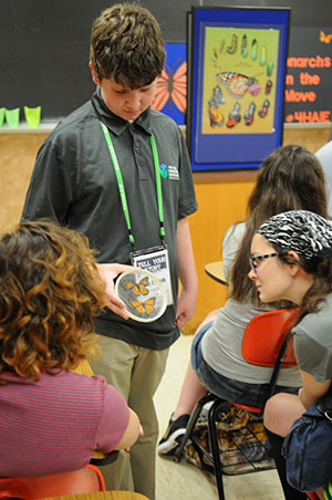 Boy teaching class on monarch butterflies, Nathan Profitt