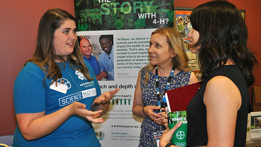 Girl talking to two women, 4-H Science Matters