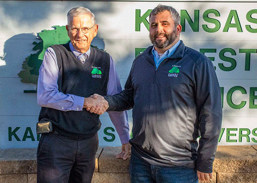 Two men shaking hands, Larry Biles and Jason Hartman Two men shaking hands, Larry Biles and Jason Hartman