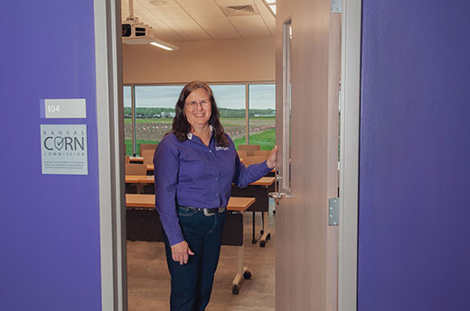 Woman standing in classroom doorway, Anita Dille Woman standing in classroom doorway, Anita Dille