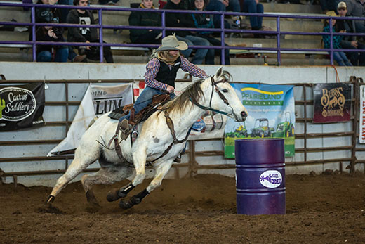 Girl on horse, barrel racing at K-State rodeo