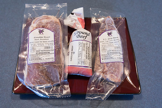 three small packages, locally produced meat products