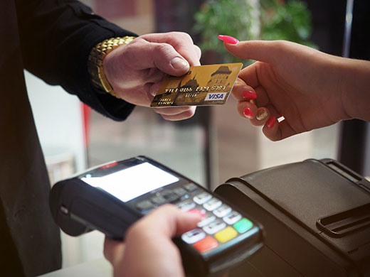 closeup photo of man paying with credit card