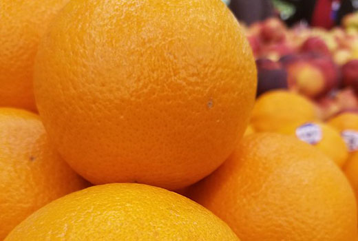 oranges in a grocery store stand
