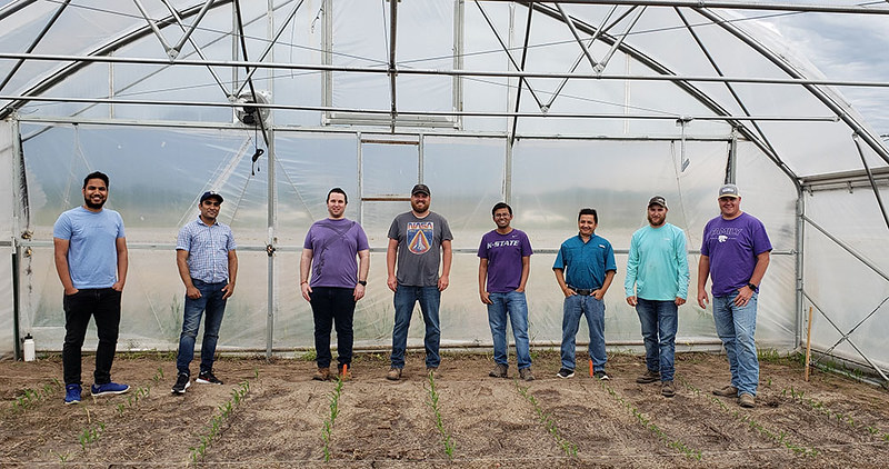 A Kansas State University research team led by Krishna Jagadish (pictured fourth from right) is using climate-controlled tents to study the effect of high night-time temperatures on corn, wheat and other crops.