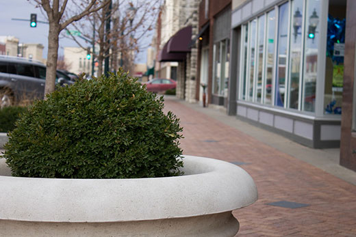 Main street sidewalk with flower planter in foreground