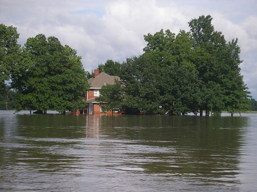 Brick house surrounded by flood water