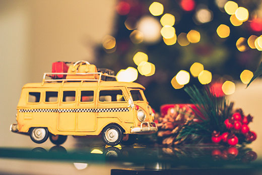 yellow school bus in front of christmas tree