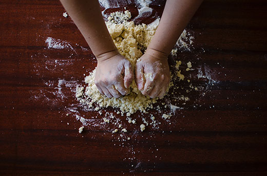 aerial view of hands kneading dough