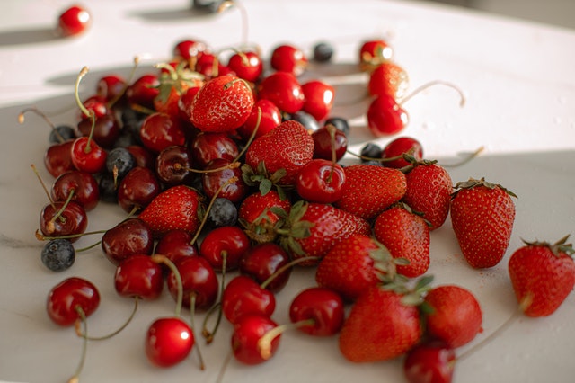 fresh produce Cherries and strawberries on a counter