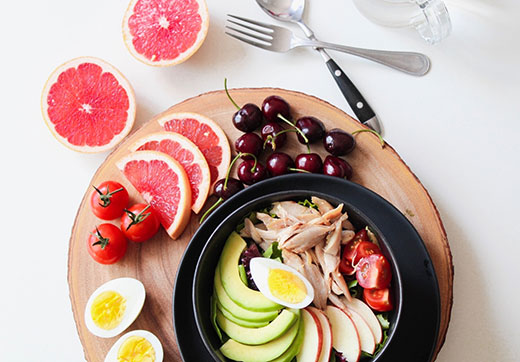 Plate with fruit, vegetables and several healthy foods