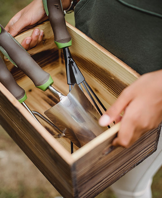 small wooden box with garden tools