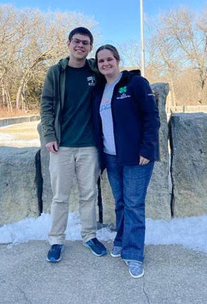 Boy and girl standing next to one another