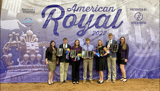 Group photo in front of American Royal banner, 4-H meat judging team