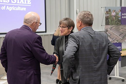 Kansas Gov. Laura Kelly shaking hands with Ernie Minton, dean of the K-State College of Agriculture