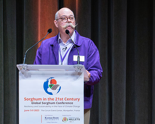Ernie Minton, speaking from podium at Global Sorghum Conference